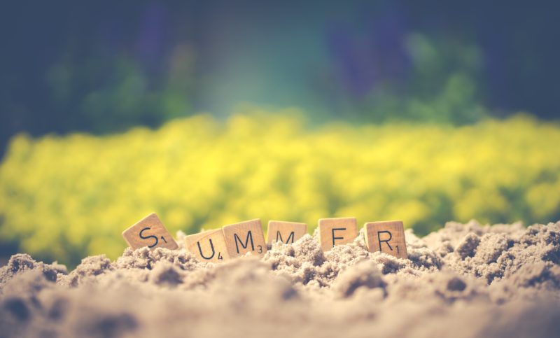 blocks spelling summer sitting on the sand